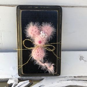 Crocheted tiny mouse on a wood plaque